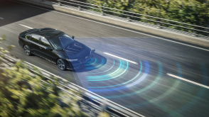 3/4 bird’s eye view of black Accord driving on city highway. Blue sensor lines and waves emit from the front.