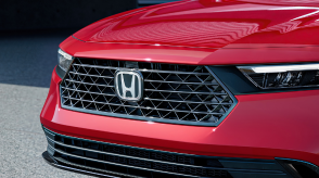 Closeup of front grille on a red Accord. 