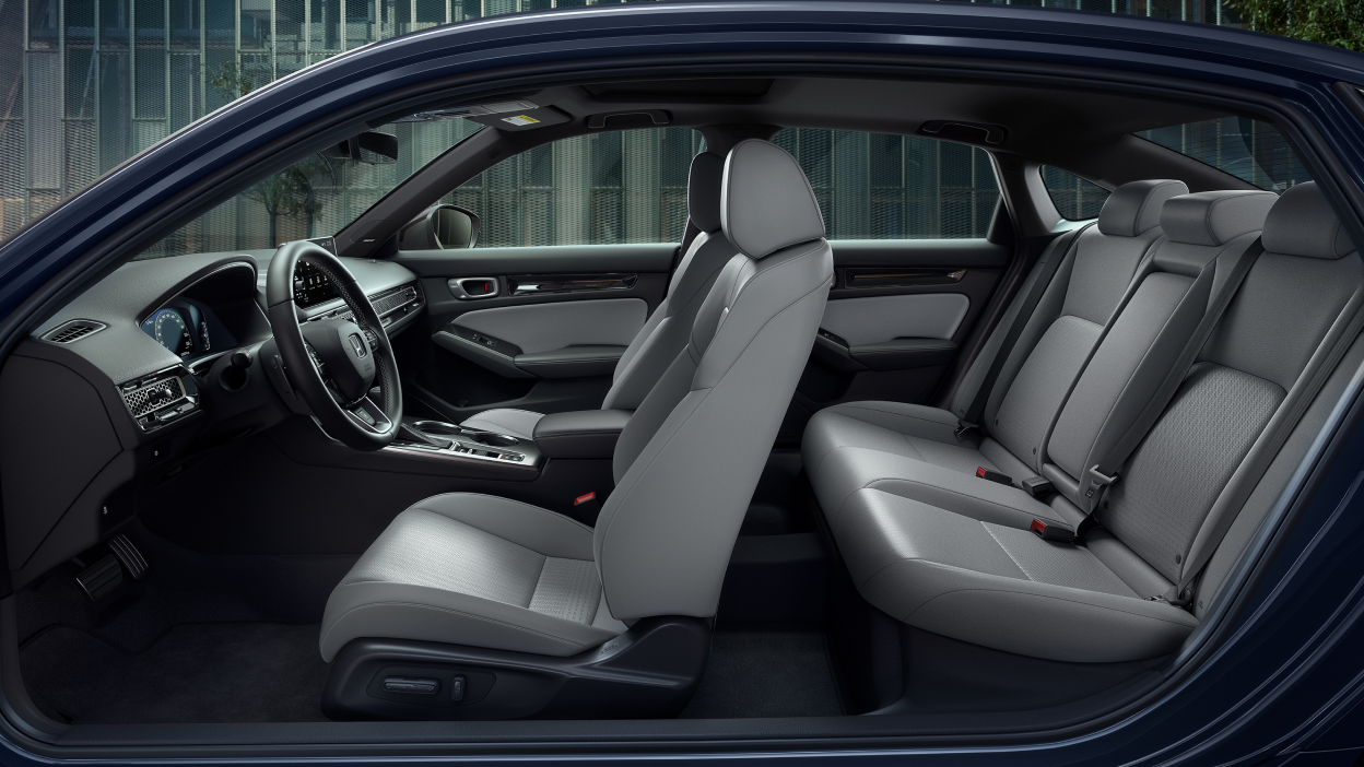 Side panoramic view of a Civic Sedan’s front and rear grey seats.