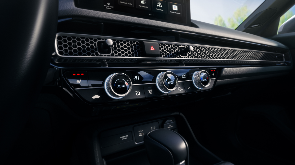 Closeup of the dials and buttons on the climate control.