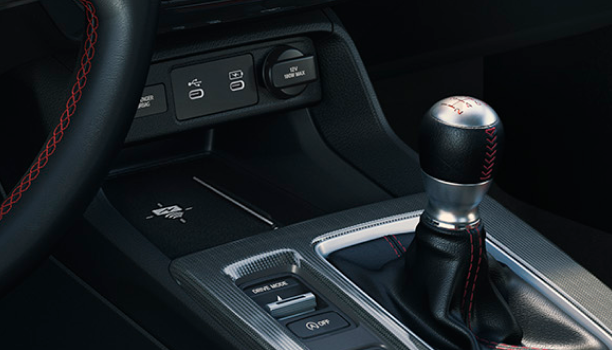 Closeup of wireless charging pad in centre console above the gear shifter. 