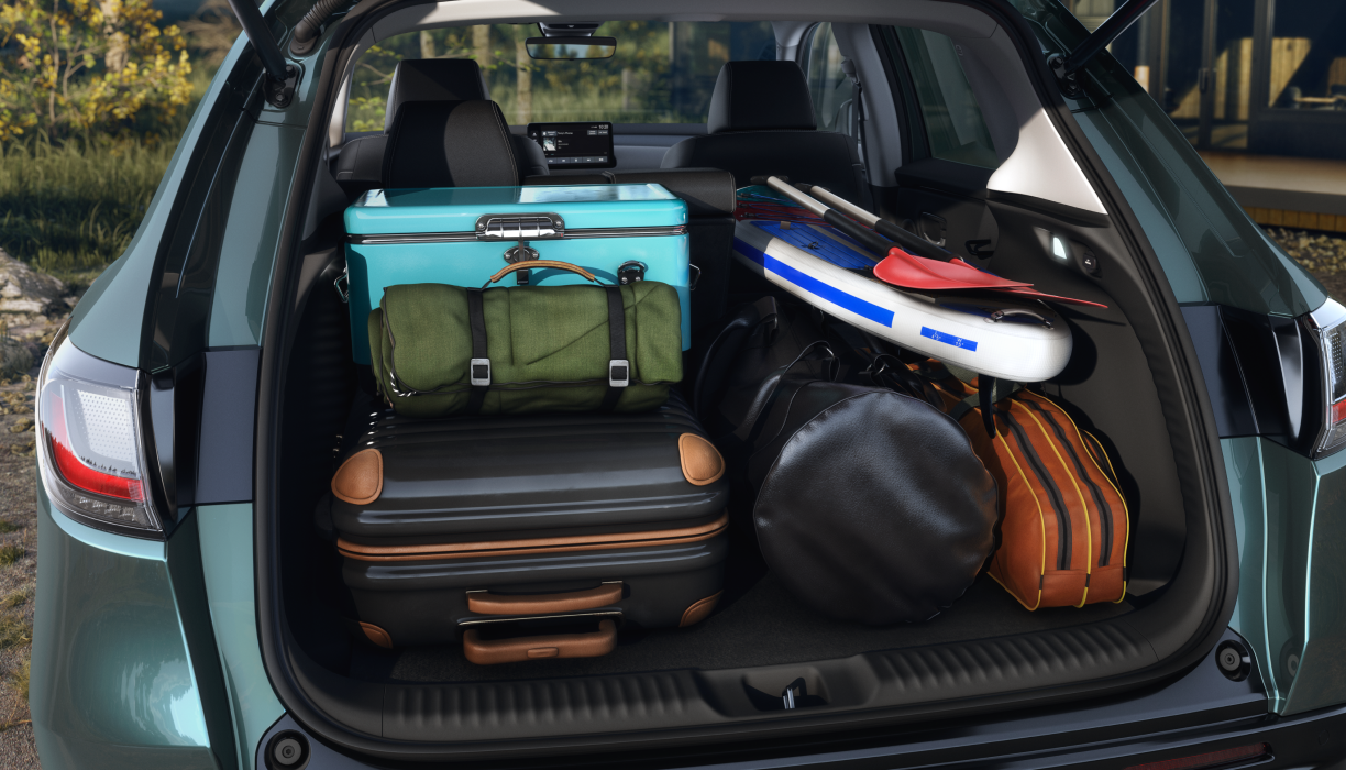 Medium closeup of open tailgate door with the cargo area full of camping and outdoor gear. 
