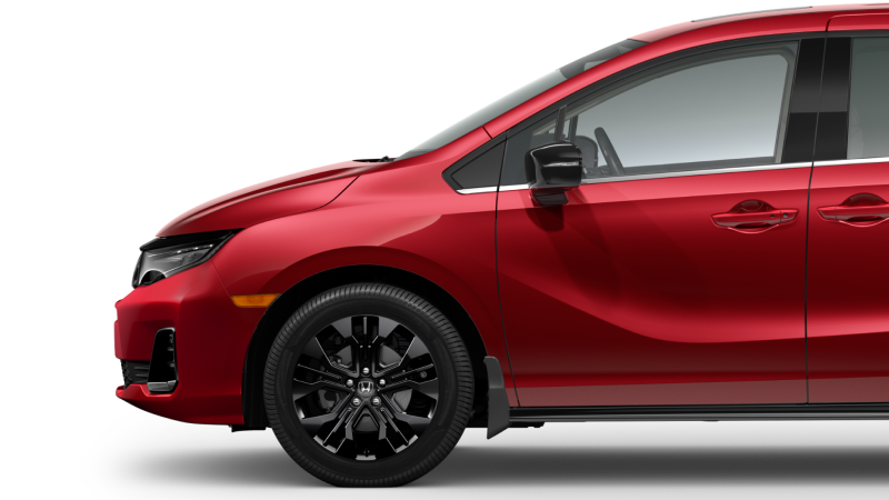 Side view of front end of a red Odyssey on white space, showcasing its black front wheel.