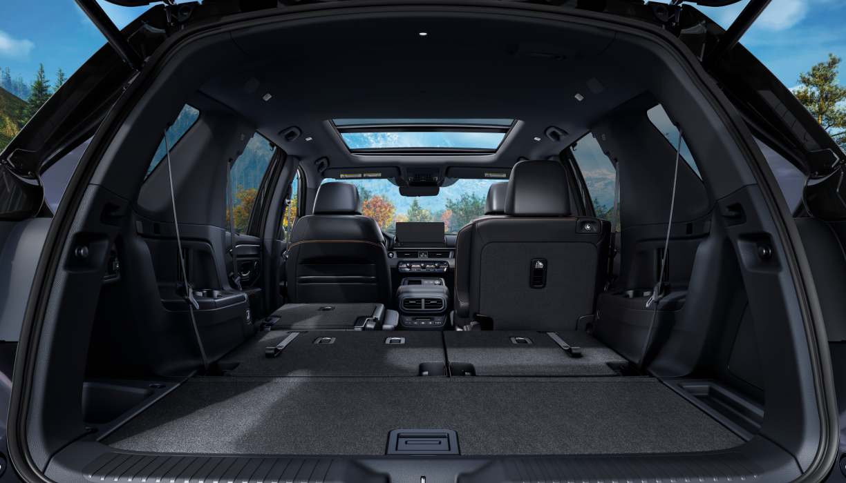 Rear view of the Pilot’s trunk interior with the back row of seats folded down.