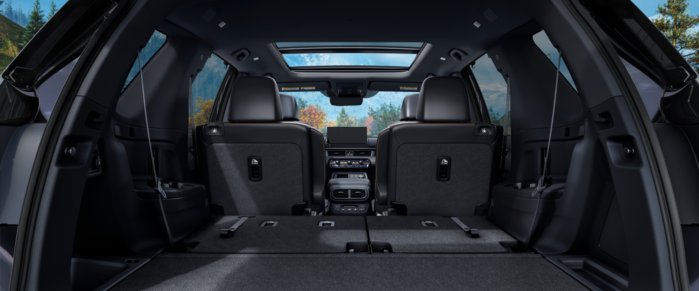 Rear view of the Pilot's interior from the open trunk, with the back row of seats folded down to showcase cargo space.