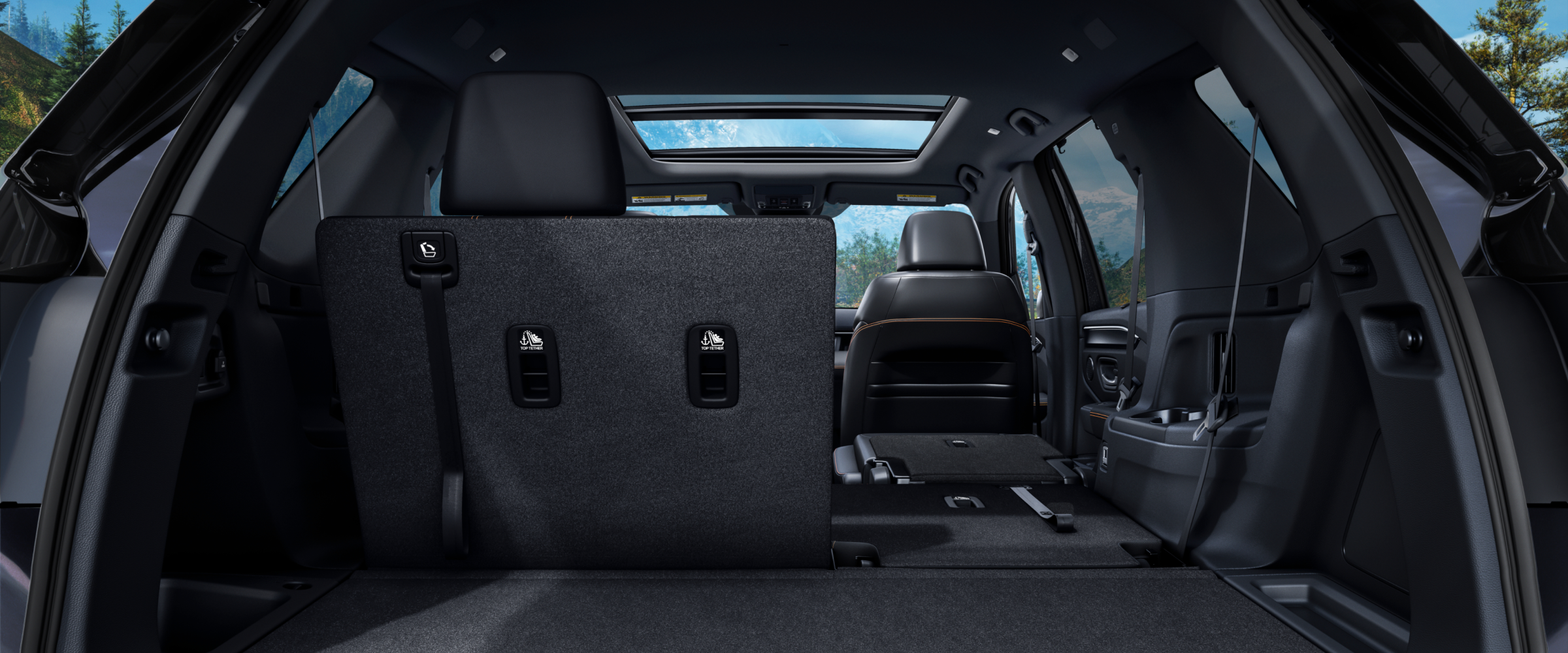 Rear view of the Pilot's interior from the open trunk, with part of the second-row seats folded down to highlight versatility.