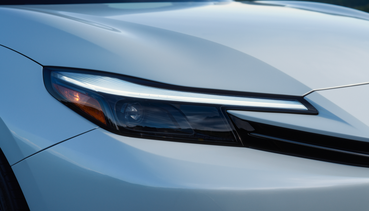 Closeup of the headlight on a White Prelude.