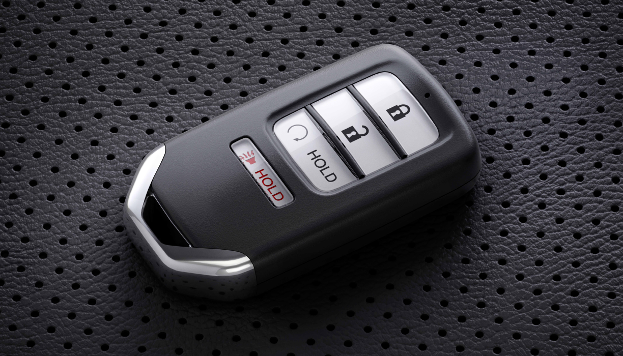 Closeup of key fob sitting on perforated seat.