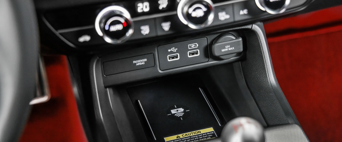 Closeup of wireless charging pad in centre console above gear shifter.