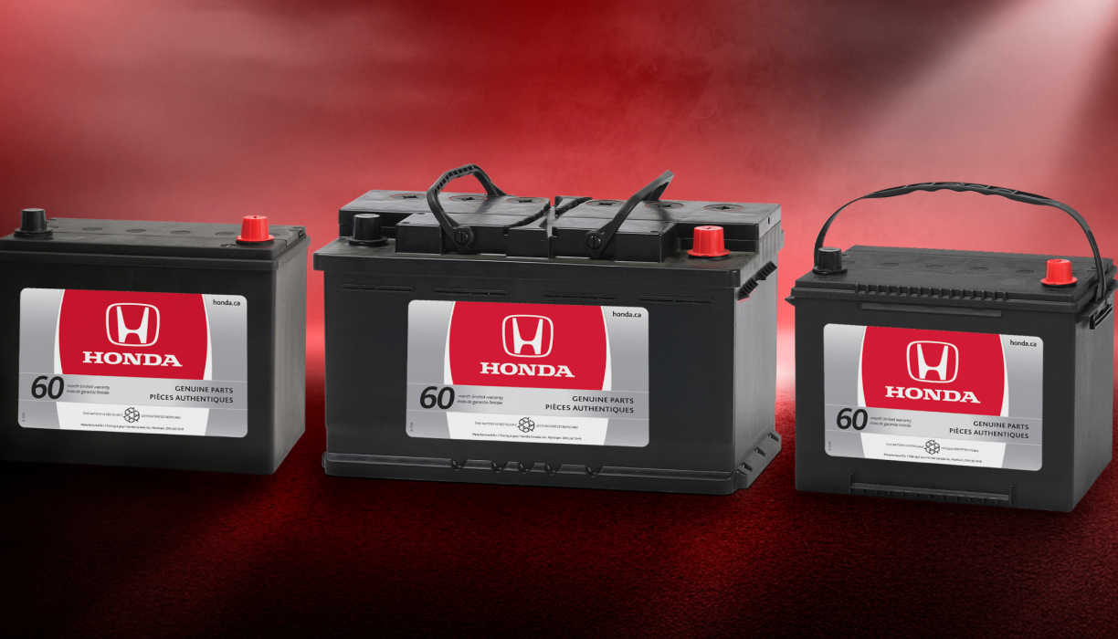 3 Honda batteries side-by-side against a hazy red background. 