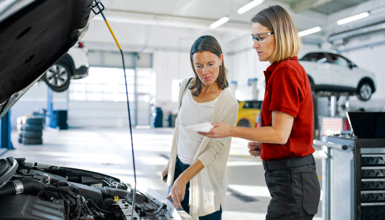 A Honda specialist performs a battery check with a customer. 